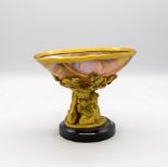 A mother-of-pearl shell bowl, the gilded stand in the form of two dogs, 12.