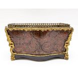 A Boulle type jardinière, gilt metal mounted on scroll feet,