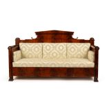 A Biedermeier flame mahogany sofa, with architectural crest rail,