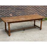 A 20th Century refectory table on turned legs with H-stretcher,