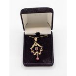 An Edwardian ruby and pearl pendant necklace, of openwork form set in 9ct gold, marked H&W,