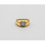 An 18ct gold star sapphire ring, the oval cabochon set stone of approximately 3.