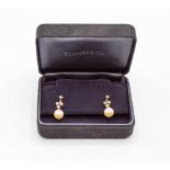 A pair of diamond and cultured pearl drop earrings, each pearl surmounted by a diamond trefoil,