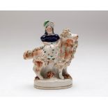 A small Staffordshire pottery flatback figure of a girl on a goat,