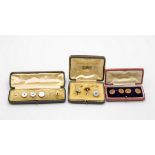 Three mother-of-pearl studs, the backs stamped 18ct, three others,