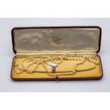 A two row cultured pearl necklace with oval marcasite clasp CONDITION REPORT: Needs