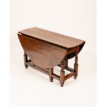 A George I oak gateleg table, the oval drop leaf top on baluster turned legs joined by stretchers,