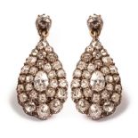 A pair of 18ct gold and diamond drop earrings of pear-shape, set with pear,