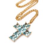 A contemporary blue topaz cruciform pendant, by Kiki McDonough,