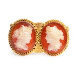 A late 19th Century double cameo brooch, set with two oval hardstone cameos,