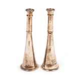 A pair of novelty silver pepper pots, makers mark worn, London 1915, modeled as hunting horns,