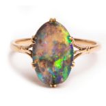 An Edwardian black opal ring, the oval flat topped opal approximately 13mm x 8.8mm x 3.