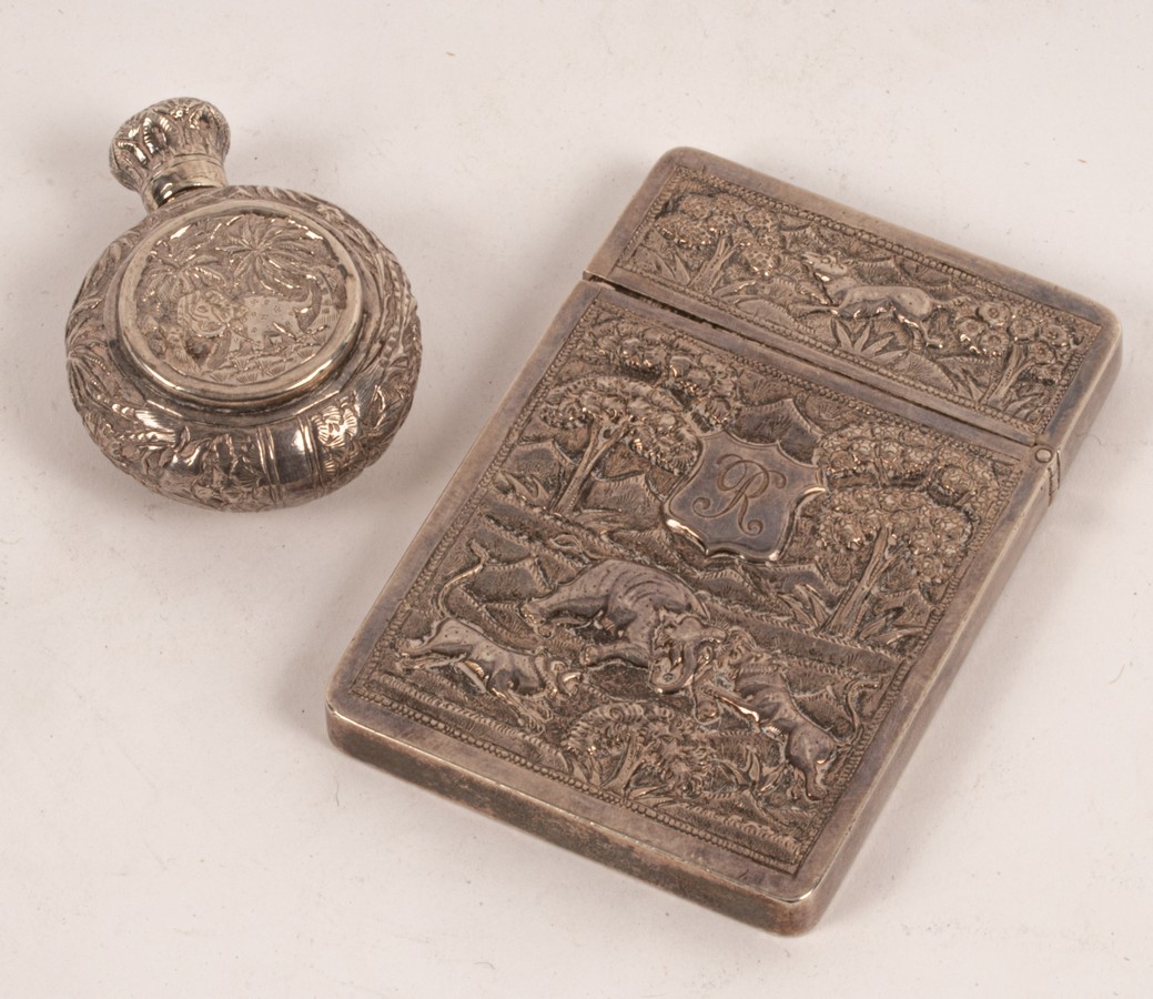 An Indian silver card case, late 19th Century, relief decoration with elephants,