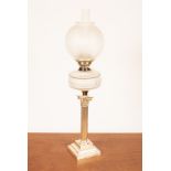 An oil lamp with etched glass shade and cut glass reservoir on plated Corinthian column support,