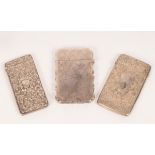 Three silver card cases, early 20th Century, engraved or repousse decorated, one with initial,