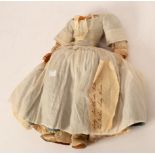 A wax headed and shouldered doll, (missing head), cloth body with wax hands,