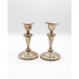 A pair of Edwardian silver mounted candlesticks, makers mark worn, Birmingham 1908,