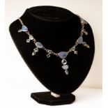 An opal and blue topaz necklace set in silver and on a silver chain