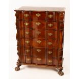 A Dutch walnut chest of six drawers, with shaped top, brass handles and on ball and claw feet,