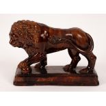 A 19th Century treacle glazed ceramic Medici lion on a moulded base, 28.