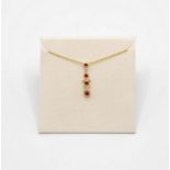 A contemporary ruby and diamond 18ct gold pendent necklace,