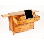 A Regency satin birch bowfront dressing chest of three drawers, the top,