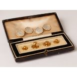 A pair of mother-of-pearl cufflinks set in 18ct gold,