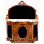 A Victorian walnut credenza, the arched mirror back above a marble top,
