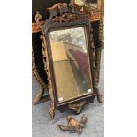 A stained mahogany fretwork mirror with parcel gilt decoration,