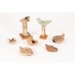 Three Roman pottery oil lamps and four shaped pottery oil lamps,