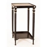 An early 19th Century ebonised and ivory mounted stand with spirally turned supports and platform
