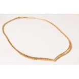 An 18ct tri-gold 'V' pointed collarette necklace, approximately 16.