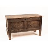 A 17th Century oak coffer, with carved panel front on straight supports, 120cm wide, 70cm high,