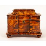 A 19th Century tortoiseshell and ivory inlaid tea caddy, the hinged moulded top with a brass plaque,