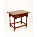 An 18th Century oak side table with frieze drawer and drop handles,