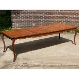 A modern parquetry topped extending dining table, on cabriole legs with two extra 57cm leaves,