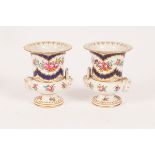 A pair of Continental porcelain small urn-shaped vases, 19th Century,