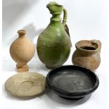Collection of Roman pottery to include a black glazed bowl, a green glazed pitcher etc.