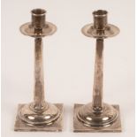A pair of Edwardian silver mounted candlesticks, Josiah Williams & Co.