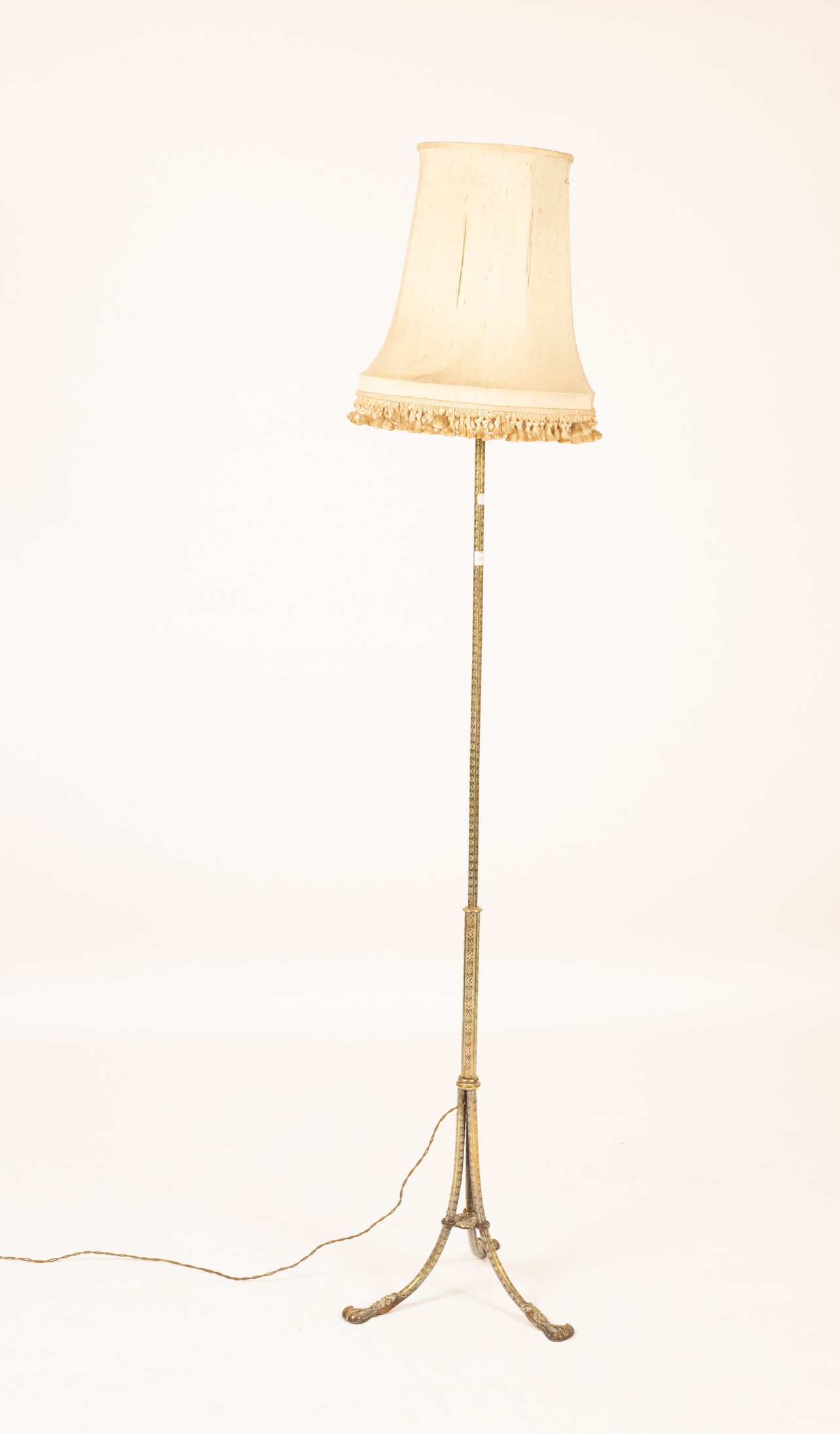 An engraved brass standard lamp CONDITION REPORT: Condition information is not