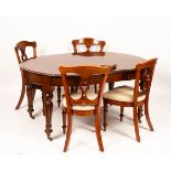 A Victorian mahogany extending dining table, the circular top extending with one leaf,