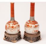 A pair of Japanese Kutani bottle vases decorated with blossom and birds, both with stands, 20.