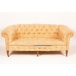 A late Victorian Chesterfield sofa, on turned front legs with castors, 190cm wide, 93cm deep,