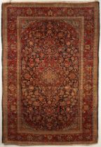 A Kashan rug, Central Persia, circa 1920, the indigo field of flowering and leafy vines,