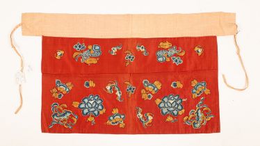 A Chinese altar/mirror cover, burnt orange/rust ground decorated with fish, bats and peonies,