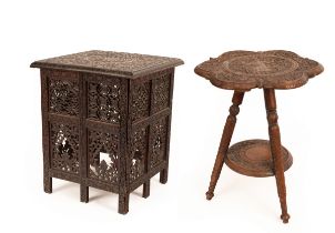 A heavily carved Middle Eastern table of square shape with pierced sides and a similarly carved