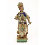 A Chinese Shiwan pottery figure of a lady, Qing dynasty, standing holding sword hilt, 55.