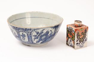 A Dutch Delft blue and white bowl painted with flowers and a square section tea caddy painted red,