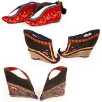 A pair of Chinese shoes for bound feet with hooked upturned toes and heel and two others,