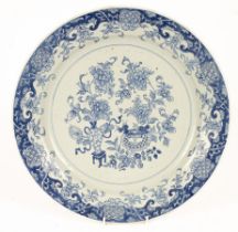 A Chinese blue and white charger, Qing dynasty, typically decorated with vase and flowers,